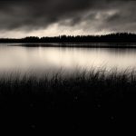 A Black And White Photo Of A Lake