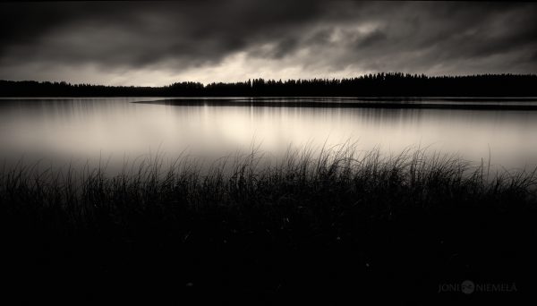 A Black And White Photo Of A Lake