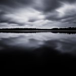 A Black And White Photo Of A Lake