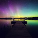 Chairs On A Dock By The Water With Northern Lights