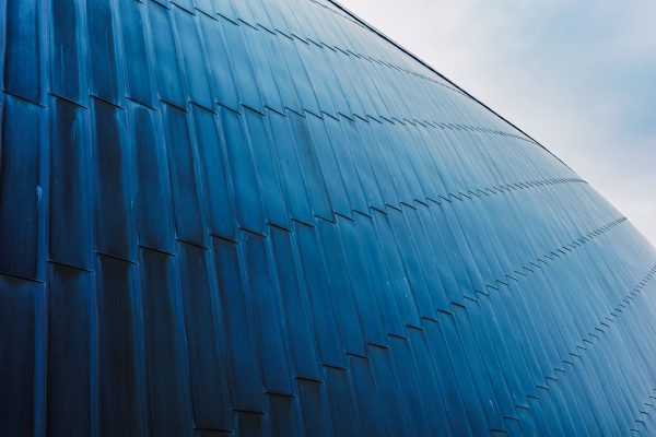 Close Up Of Blue Building Under Cloudy Sky