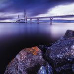 Dramatic Evening Sky Over The Replot Bridge And Rocky Shoreline In Finland