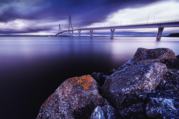 Dramatic Evening Sky Over The Replot Bridge And Rocky Shoreline In Finland