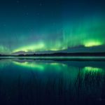 Glowing Green Lights Reflecting On Lake
