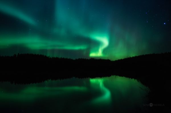 Green And Blue Aurora Borealis Over A Lake