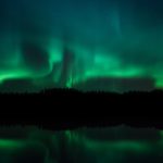 Green And Blue Aurora Borealis Dancing Over Lake