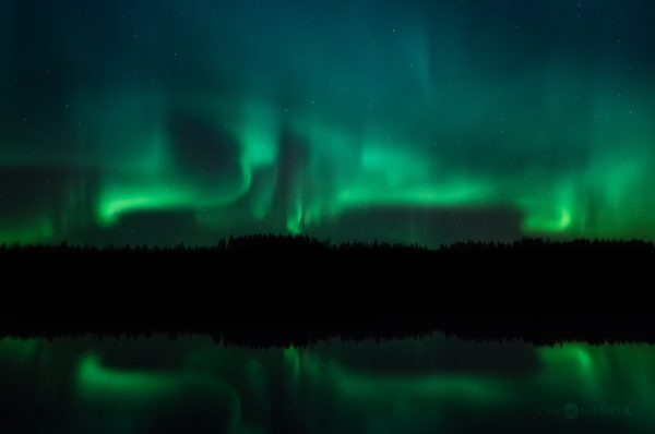 Green And Blue Aurora Borealis Dancing Over Lake
