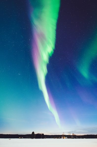 Green And Purple Aurora Borealis Illuminating The Sky