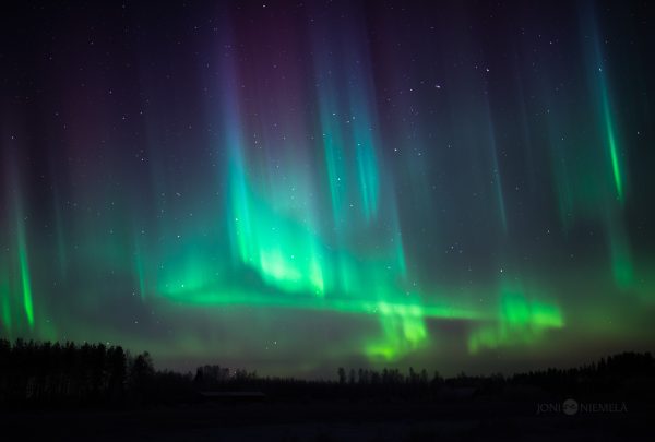 Green And Purple Aurora Borealis Illuminating Night Sky