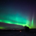 Green And Purple Aurora Borealis In The Night Sky