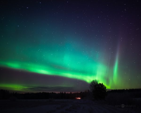 Green And Purple Aurora Borealis In The Night Sky