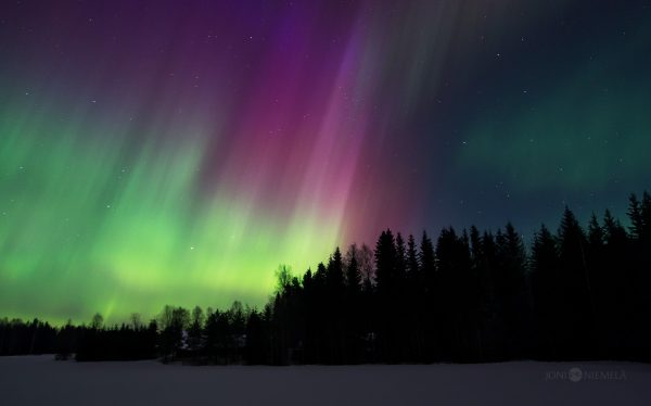Green And Purple Aurora Borealis In The Night Sky