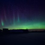 Green And Purple Aurora Borealis In The Night Sky