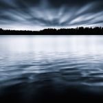 Large Body Of Water Under Cloudy Sky