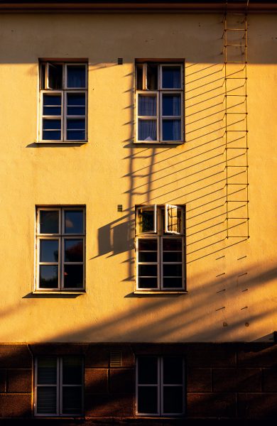 Late Afternoon Sunlight Casts Shadows On Urban Building In Quiet Neighborhood