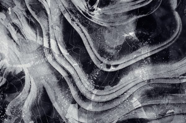 Monochrome Abstract Texture With Swirling Ice Patterns Captured In Close-Up