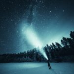 Person Standing In Snow Under Night Sky