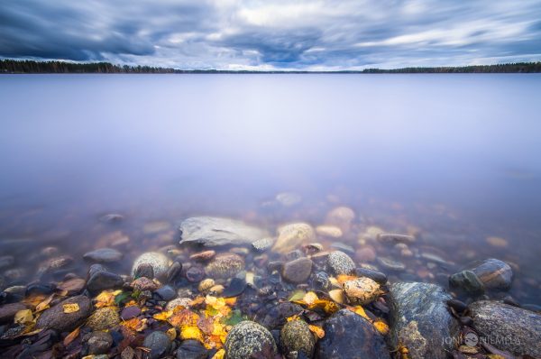 Rocky Water Body Under Cloudy Sky
