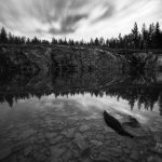 Serene Monochrome Landscape Of A Tranquil Lake At Dusk With Reflective Waters And Dynamic Skies
