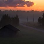 Serene Sunset Over A Secluded Cabin In A Misty Forest Clearing