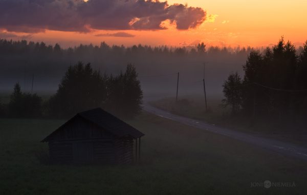 Serene Sunset Over A Secluded Cabin In A Misty Forest Clearing