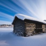 Snow-Covered Barn In A Serene Winter Wonderland During Twilight