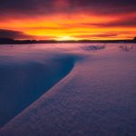 Snow Covered Field With Sunset