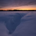 Snow Covered Field With Sunset