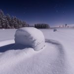 Snow-Covered Haybales Under A Starlit Sky