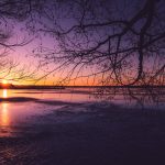Sun Setting Over Frozen Lake