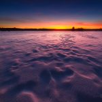 Sun Setting Over Frozen Lake