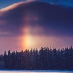 Sundog Appears In Sky Over Snow Covered Field